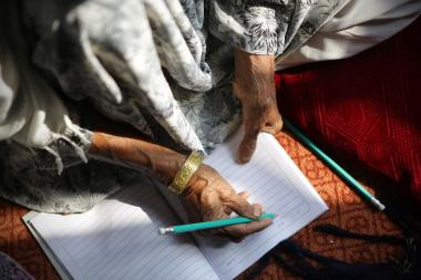 A woman, 60, practices numeracy in class