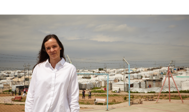 Brita Fernandez Schmidt in front of the Khanke camps for internally displaced people. Photo credit: Aidan O'Neill
