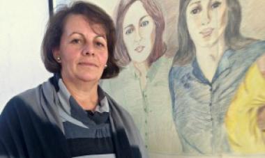 woman in front of painting (Remzije Berisha)