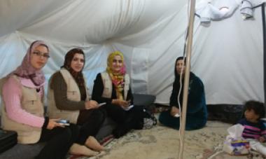 women in scarves sitting in tent