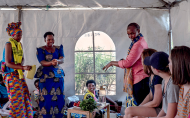 Tricia and her daughters sit in on a social empowerment class about health and nutrition.