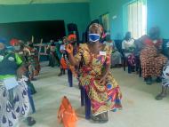 Saratu in her class, with a face mask on and socially distanced