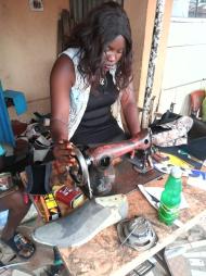 Saratu's younger daughter making shoes