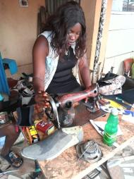 Saratu's younger daughter making shoes