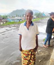 Justine standing in her village