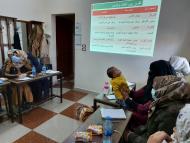 A group of women sit in a classroom