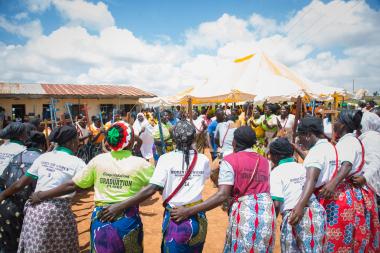 Women gathered in a circle with arms around each other