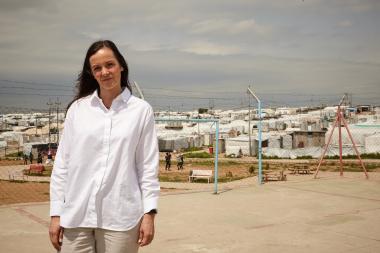 Brita Fernandez Schmidt in front of the Khanke camps for internally displaced people. Photo credit: Aidan O'Neill