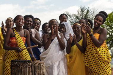 Participants in Rwanda gathered with drums and clapping, laughing, and celebrating; Photo credit: GiveWith