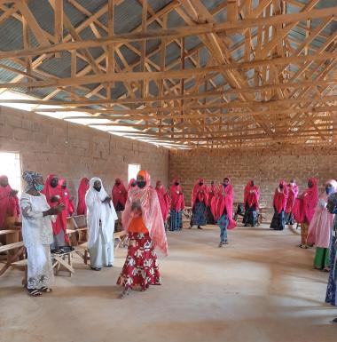 Many women gather in the graduation clothes of red to celebrate their graduation from the program