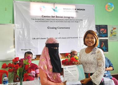 A participant of WfWI's training in Myanmar poses with her diploma. 