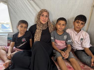 Tahreer Abu Suleiman with her children in their tent, Gaza