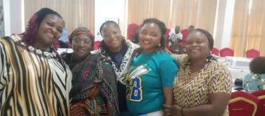 Lyop standing with other women