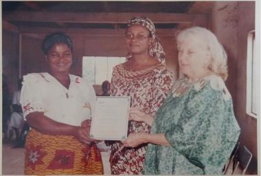 Buki and Jean giving out a certificate