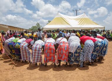 people gathered bending over