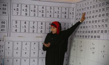 Instructor in front of numbers on a wall