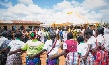 Women gathered in a circle with arms around each other