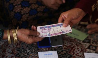 Afghanistan - women passing money