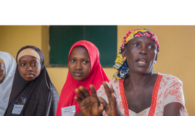 A class of 25 women from both Fulani herder and Christian farmer communities learning together in the Women for Women International year-long training program. Photo: Monilekan