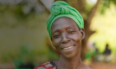 smiling woman in green headwrap