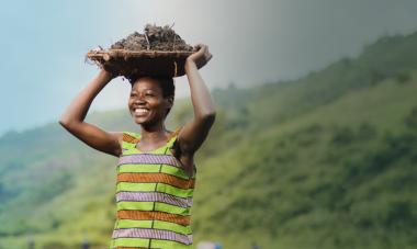 hero smiling woman from rwanda with basket on head