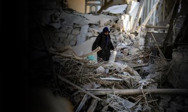 Woman searches through earthquake rubble