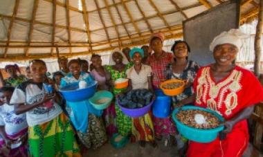 group of women smiling and holding bowls