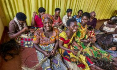 women in colorful dresses sitting and talking