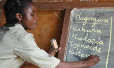 woman writing on chalk board 