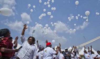 women releasing balloons into the air