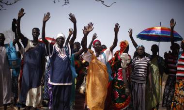 people celebrating with their hands raised