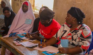 women taking notes in program