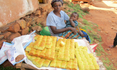 woman with baby selling bread rolls