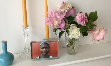 photo and flowers on a mantel