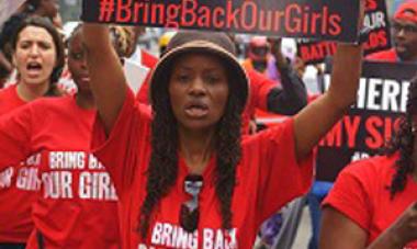 women protesting in red shirt and a hat