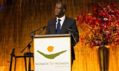 man in black suit and blue tie on stage giving a speech (Mukwege)