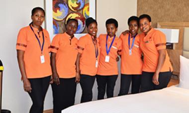 Marriott staff in orange shirts looking at camera 