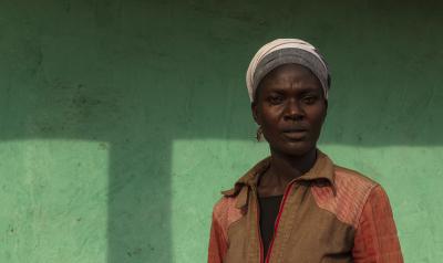 woman in front of green wall