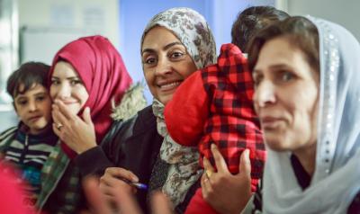 Group of women in Iraq laughing. Photo credit: Emily Kinskey