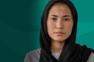 Young Afghan Woman Direct Eye Contact Teal Background