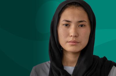 Young Afghan Woman Direct Eye Contact Teal Background