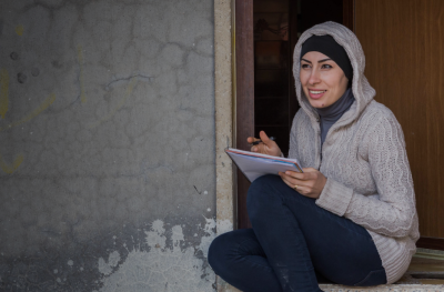 Woman writing and smiling