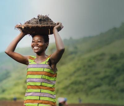 hero smiling woman from rwanda with basket on head