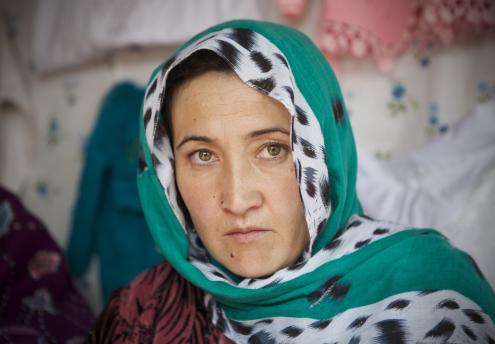 Emotive woman in green headscarf from Kabul, Afghanistan
